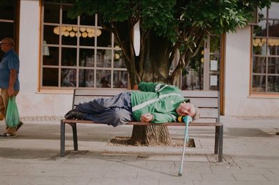 Man sitting on seat in yard