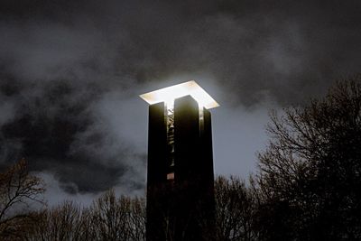 Low angle view of tower against cloudy sky