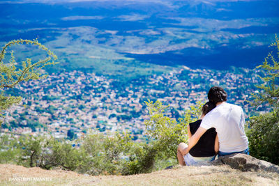 Couple sitting on the top of the mountain