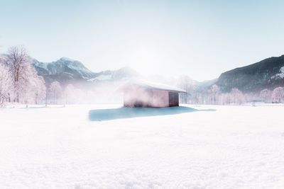 Snow covered landscape against clear sky