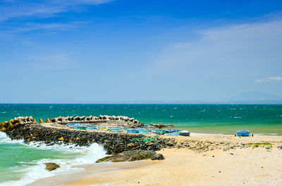 Scenic view of beach against blue sky