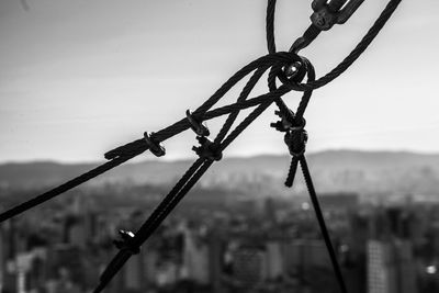 Close-up of barbed wire against sky