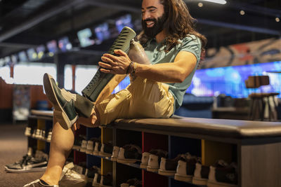 Happy man with artificial leg wearing bowling shoe