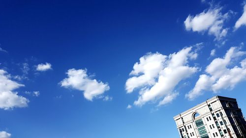 Low angle view of building against blue sky