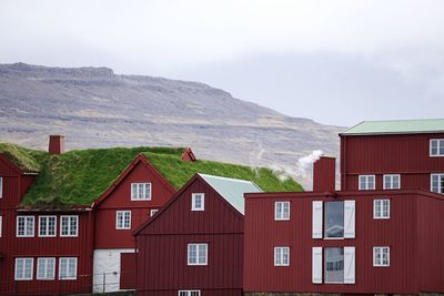 Houses against mountain range