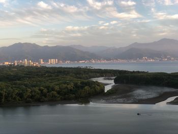 Scenic view of river and mountains against sky