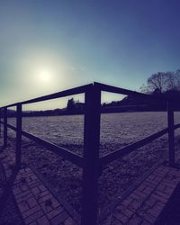 Footpath by sea against clear sky