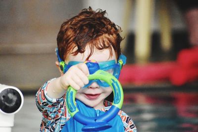 Portrait of cute boy playing in a pool