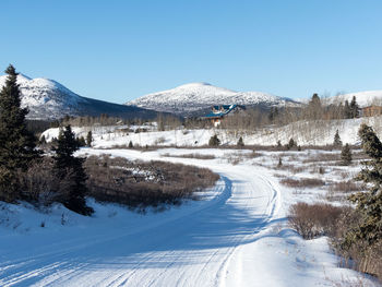 Scenic view of snowcapped mountains against clear blue sky