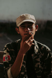 Portrait of young man smoking cigarette