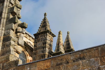 Low angle view of historic building against cloudy sky