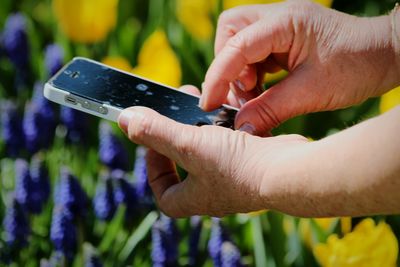 Close-up of person using mobile phone outdoors