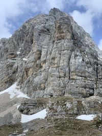 Low angle view of rock formation against sky