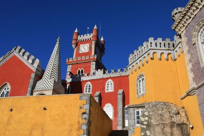 Low angle view of temple against clear blue sky