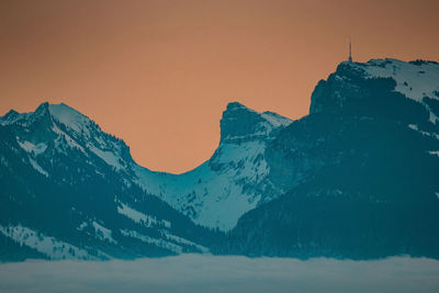 Scenic view of snowcapped mountains against clear sky during winter