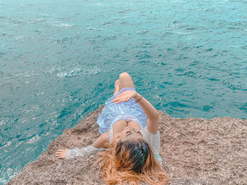 High angle view of woman relaxing in sea