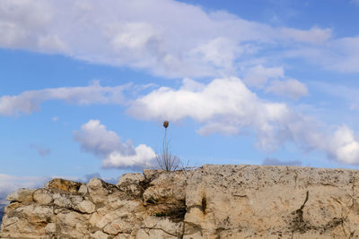 Low angle view of rock formation against sky