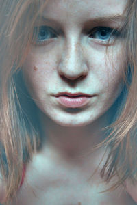 Close-up portrait of beautiful young woman with blue eyes