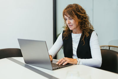 Young woman using laptop at home