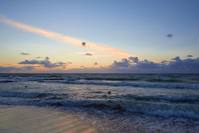 Baltic sea beach with waves at sunset