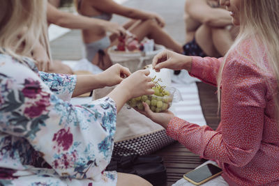 Women's hands holding grapes