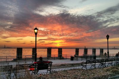 Scenic view of sea against cloudy sky at sunset