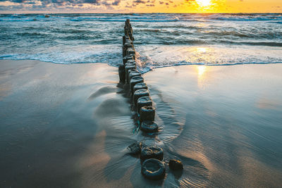 High angle view of wooden posts in sea