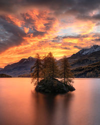 Scenic view of lake against orange sky