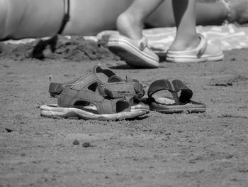 Low section of person sitting on sand