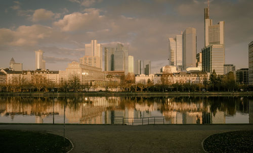 Reflection of buildings in lake against sky