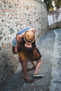 Young couple kissing on footpath