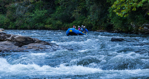 Scenic view of river flowing amidst rocks