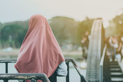 Rear view of woman standing outdoors