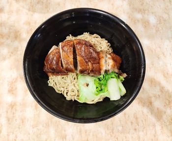 High angle view of food in plate on table roast duck noodels