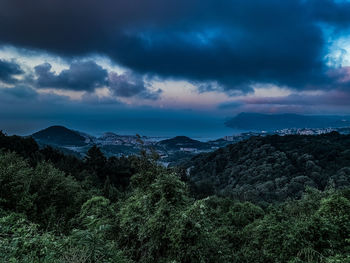 Scenic view of trees and mountains against sky