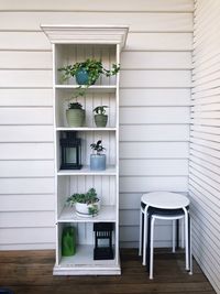 Potted plants on shelves at home on deck 