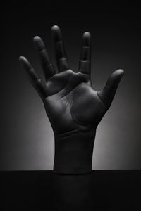 Close-up of human hand against black background