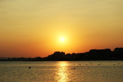Scenic view of sea against orange sky