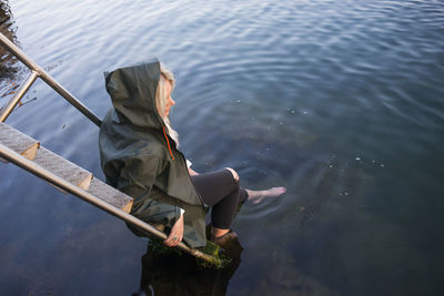 Woman with feet in sea barefoot