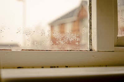 Close-up of wet glass window in rainy season