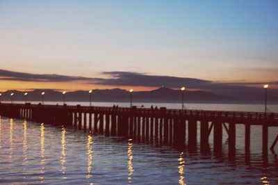 Reflection of clouds in sea at sunset