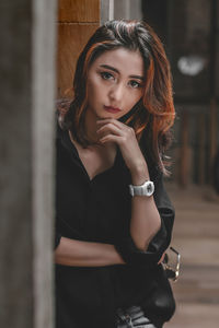 Portrait of beautiful young woman standing outdoors