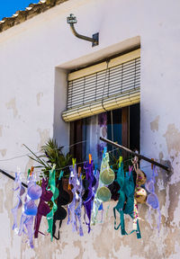 Multi colored umbrellas hanging on window