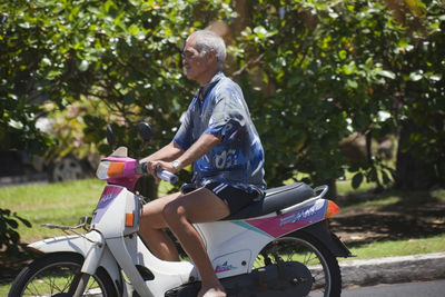 Side view of man riding motorcycle