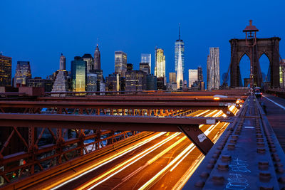 View of bridge over city at night