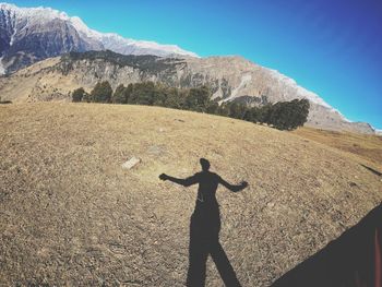 Shadow of man on mountain range against sky