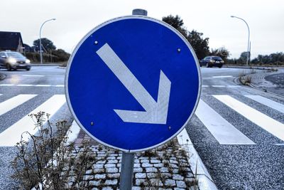 Close-up of road sign on street in winter