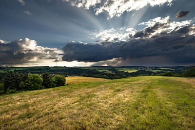Scenic view of field against sky during sunset
