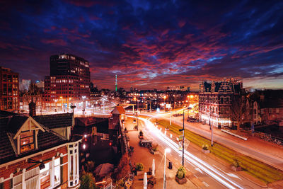 High angle view of illuminated cityscape against sky at night