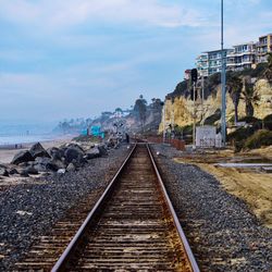 Surface level of railway tracks against the sky